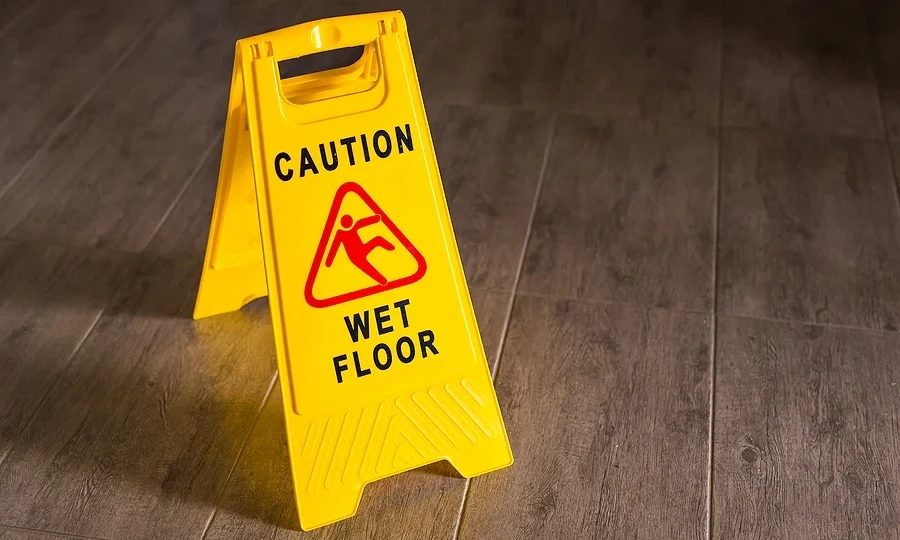 Wet floor sign on wooden floor