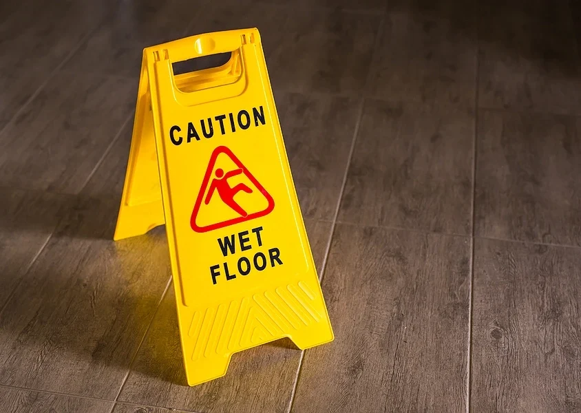 Wet floor sign on wooden floor